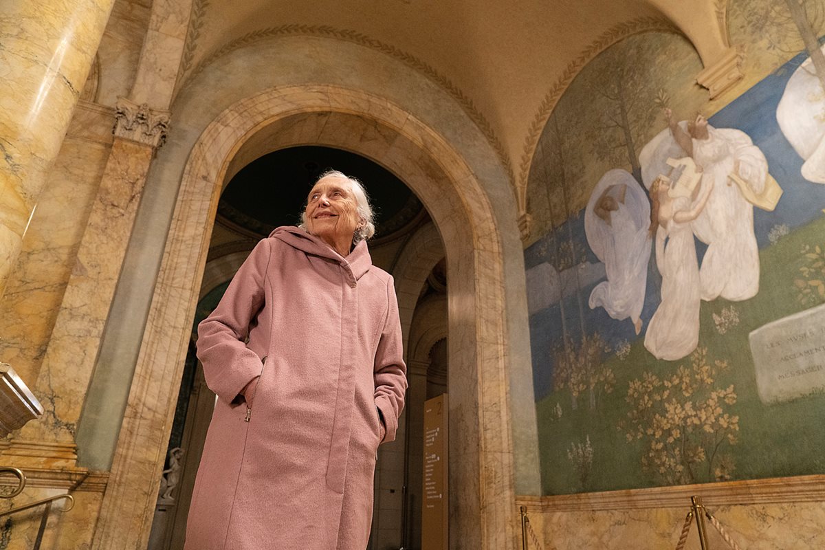 Jean Gibran walks past the mural, “The Muses of Inspiration Hail the Spirit, the Harbinger of Light,” by Pierre Puvis de Chavannes, in the Boston Public Library near Copley Square, where Kahlil Gibran spent time studying and writing. 