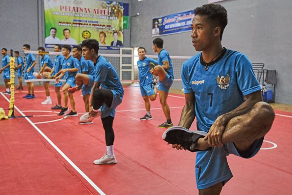The Indonesia national men’s sepak takraw 
 team members warm up at their training center in Sukabumi, West Java. The team practiced twice a day in November before going to the Philippines for the Southeast Asian Games, where they won both gold and bronze medals. 