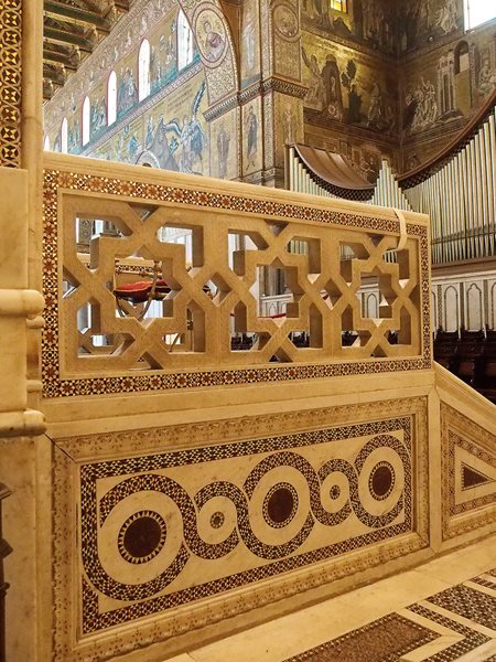 Near the sanctuary in the cathedral of Monreale, a marble balustrade shows a pattern that is purely Islamic, and mosaics both on its lower register