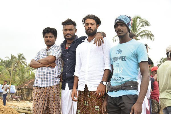 Fishing remains an occupation along the Keralan coast, where near the Port of Ponnani, four fishermen posed for a portrait. 