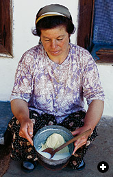 fresh butter being gently kneaded to separate out the buttermilk, or ayran, before shaping the butter.