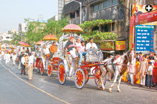 Top: In Rajasthan, India, a shop sells brightly patterned sunshade umbrellas, which are still used in wedding and festival processions such as this one above.