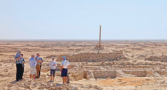 Project director Ingolf Thuesen of the University of Copenhagen shows visitors the market and workshop area of Al Zubarah. For the past four years, an international team of more than 70 experts has worked at the site each autumn and winter, researching, surveying, excavating and cataloging.