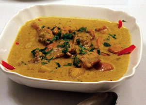 At the Lashko home, Omani chicken coconut curry, top, is smooth and mild, and it lacks the lemongrass and hot peppers that are familiar in the recipe's better-known counterparts from Thailand.