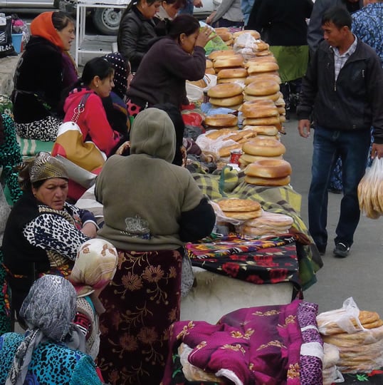 At the Ulugbek non bazaar in Samarkand, bread vendors pile their tables with non and festive patyr bread.