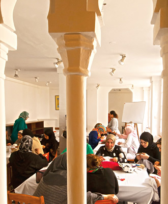 Women gather in an embroidery class. 