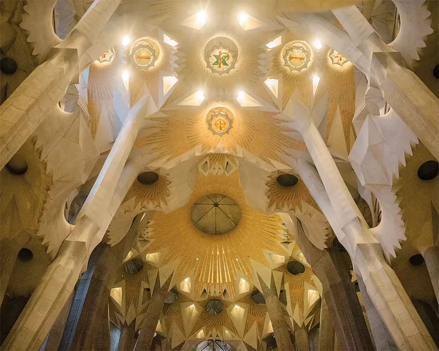 Inside the Sagrada Família, branching columns evoke a forest while colored light filters through stained-glass windows. Here, Gaudí transformed ideas about nature, structure, light and spirituality into an architectural language of his own.