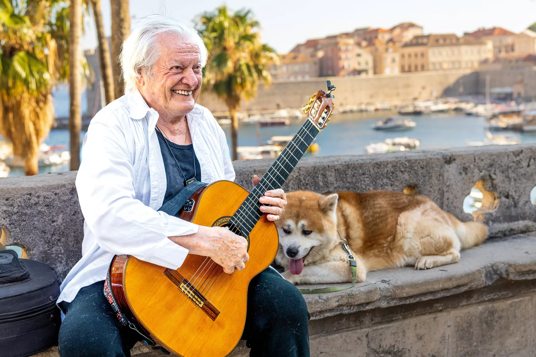 Singer-songwriter Ibrica Jusić, with his dog Simba, is a sevdalinka fixture in the Old Town of Dubrovnik, Croatia, on the coast of the Adriatic Sea. 