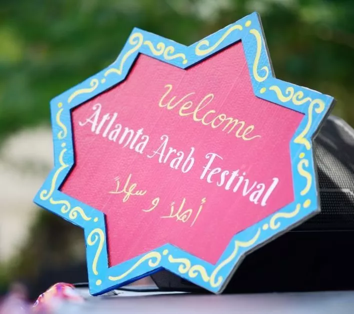 A sign welcomes visitors in English and Arabic to the annual Atlanta Arab Festival, held October 7-8, 2026, at Alif Institute in Atlanta. 