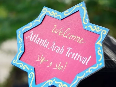 A sign welcomes visitors in English and Arabic to the annual Atlanta Arab Festival, held October 7-8, 2026, at Alif Institute in Atlanta.