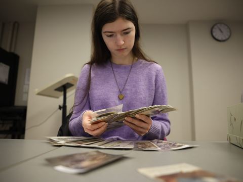 Western University student studies postcards, as a way to carry curiosity into critical thinking skills.