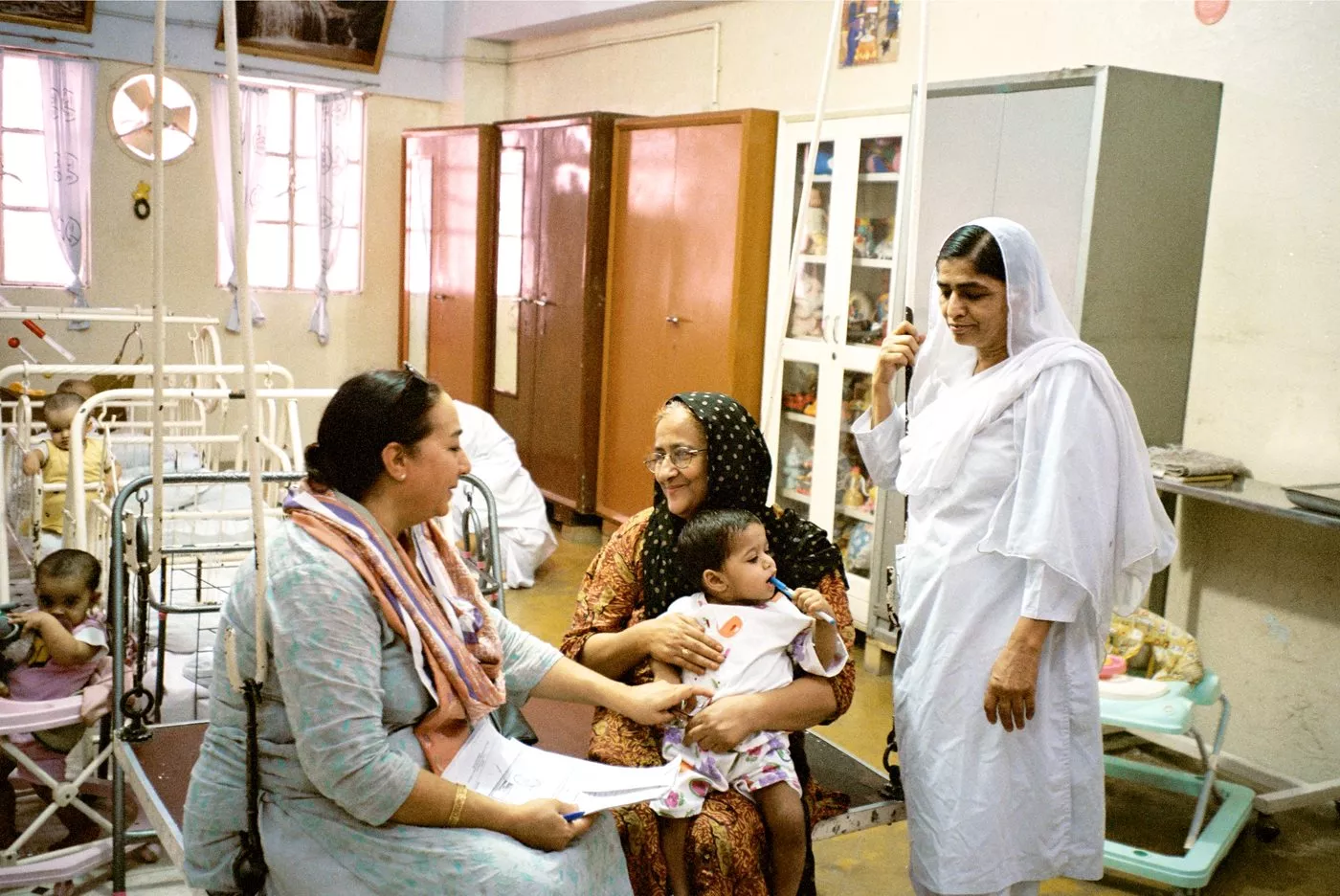 Bilquis Edhi, center, has overseen the Edhi Foundation's more than 16,000 adoptions as well as the development of hospitals and vocational services for women and a home for girls.