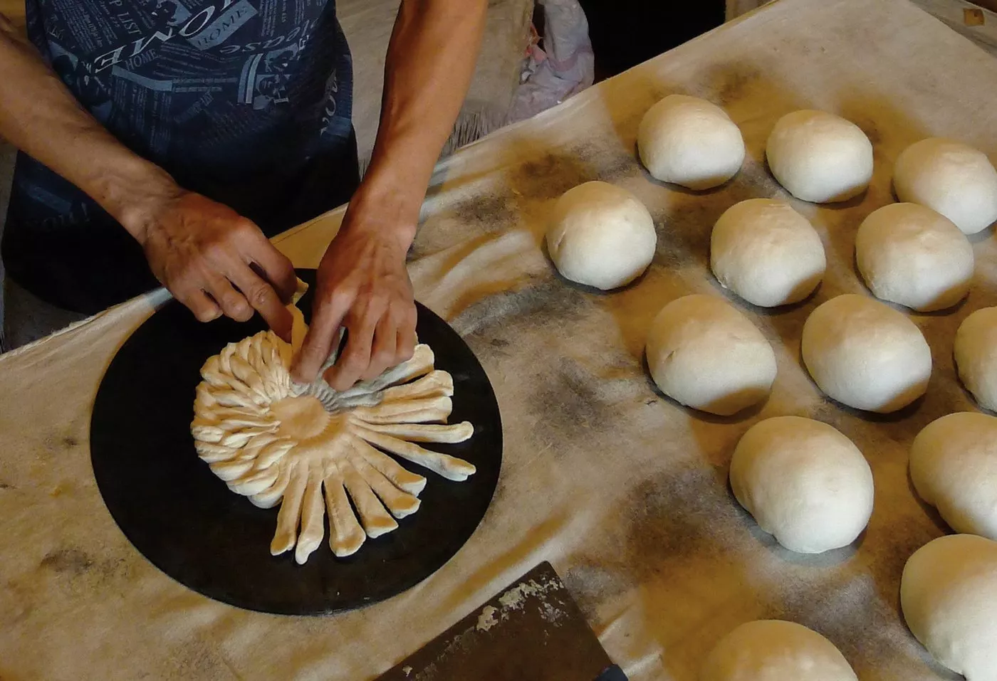 Raushanbek Ismailov is a&nbsp;<em>nonvoy</em>&mdash;a bread baker; here, he braids a decorative, Tashkent-style non.