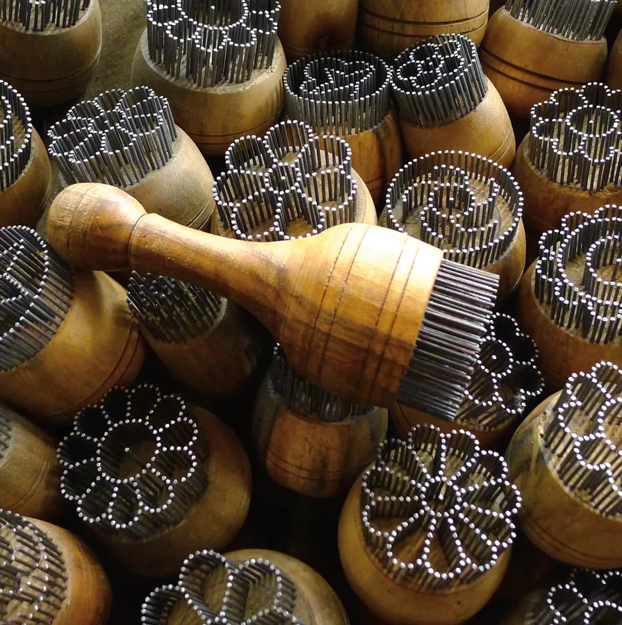 <p>At the Chorsu bazaaar in Tashkent, the tools used to decorate non are works of art in themselves. <em>Chekich</em> (bread stamps), <em>top</em>, often are made of nails arranged in patterns. They prevent the center of a loaf from rising too high, and the holes they create allow steam to escape.</p>
