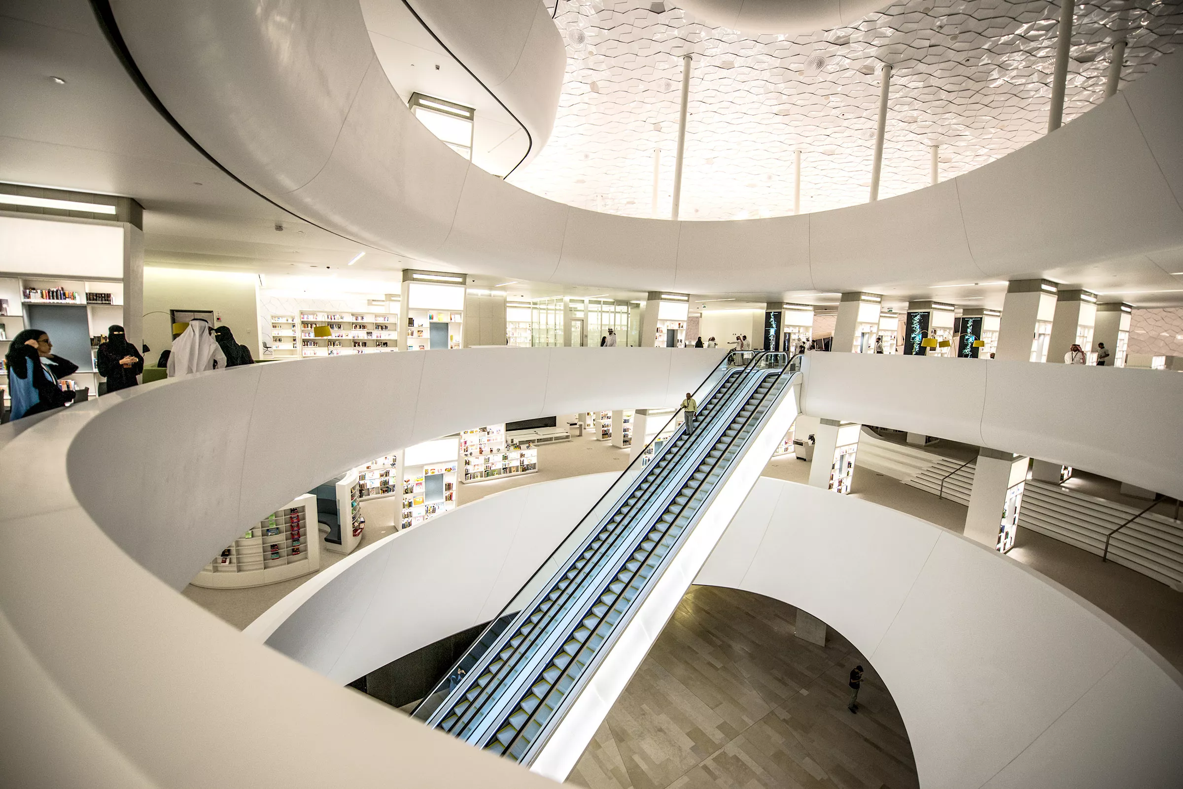 Ithra, Saudi Arabia - Rising from the plaza level, the escalator at the center of Ithra takes visitors to the library, the original impulse for the complex. On the library’s shelves are more than 200,000 books in both Arabic and English. Around them are spaces for reading, study,
research and collaboration over latte from the café.
