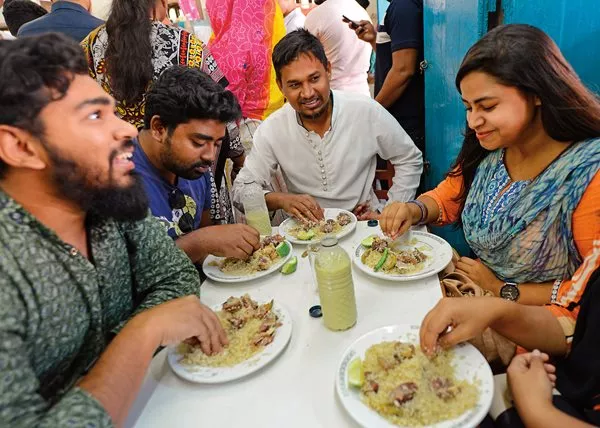 Rolling rice and meat with the right hand is the traditional way to dine on biryani at the Original Haji Biryani in Dhaka, Bangladesh.