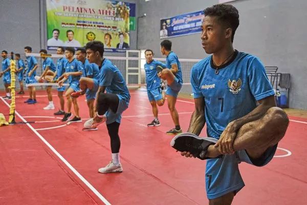 The Indonesia national men’s sepak takraw 
 team members warm up at their training center in Sukabumi, West Java. The team practiced twice a day in November before going to the Philippines for the Southeast Asian Games, where they won both gold and bronze medals. 