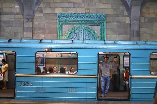 Passengers wait for the doors to close at Alisher Navoiy station, named after the 15th-century founder of Uzbek language and literature.