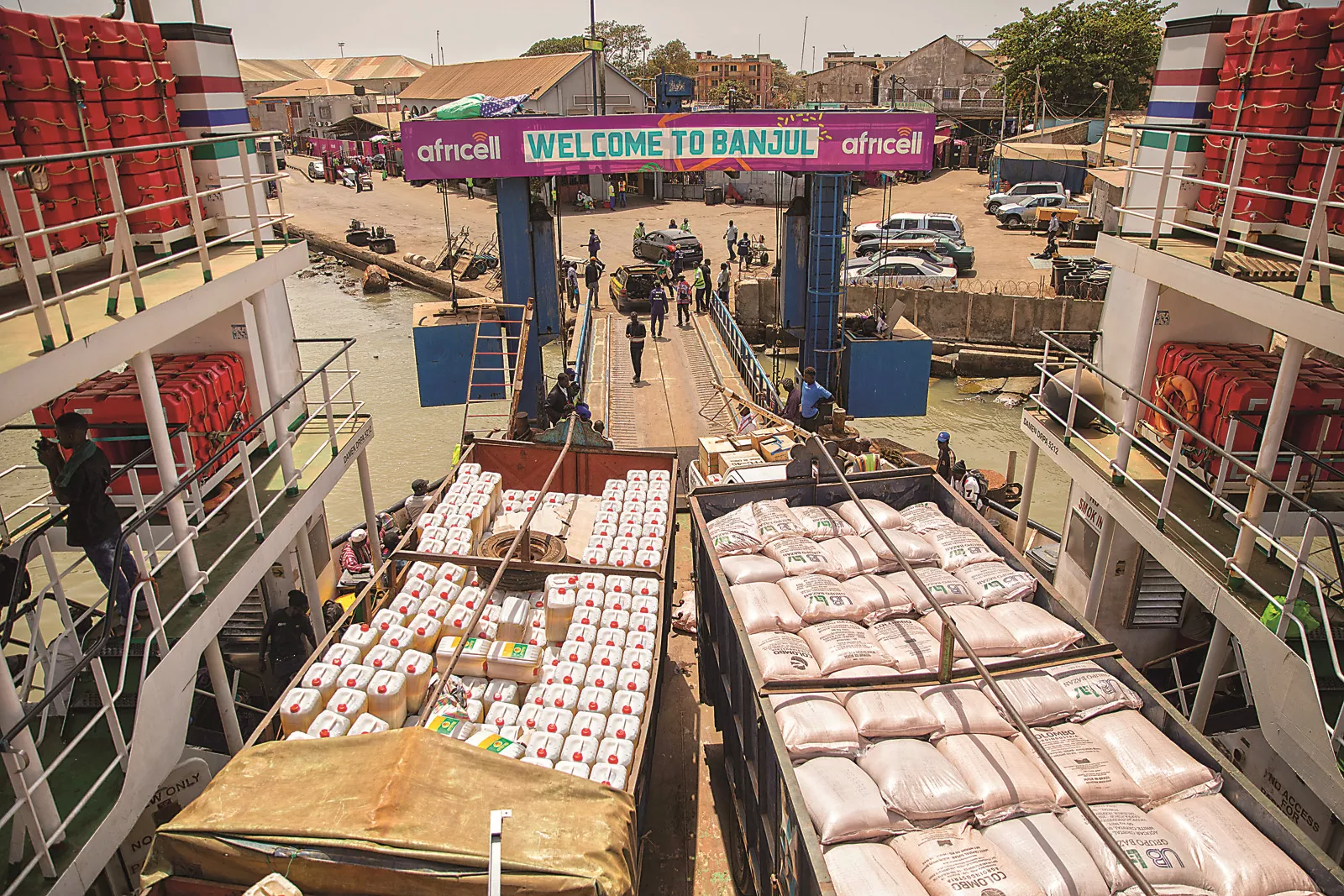 Trucks loaded with agricultural products fill the deck of the ferry that connects Banjul with Barra across the River Gambia. The river runs the length of Gambia and roughly divides it. 
