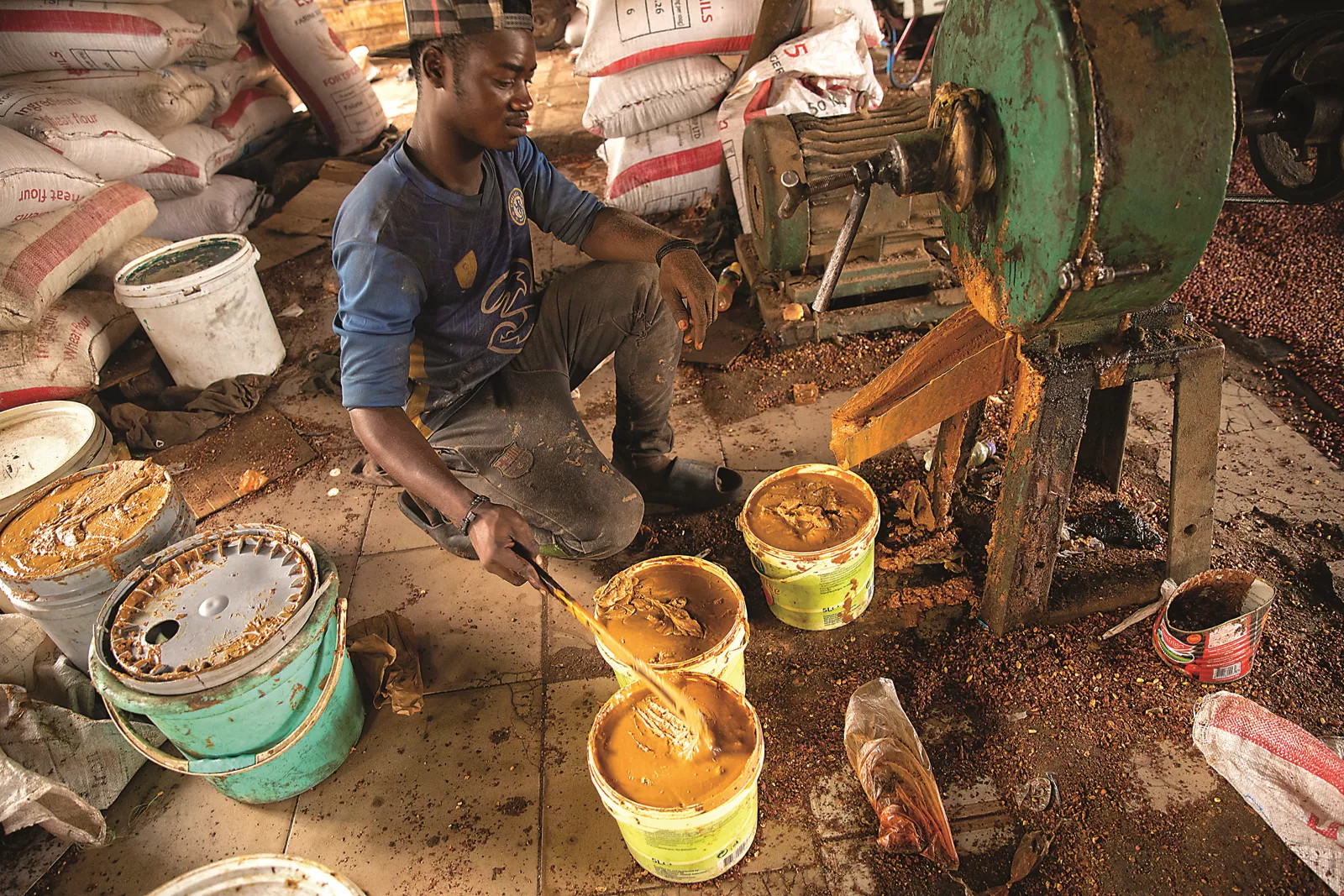 One of Ceesay’s employees paddles peanut butter into tubs from one of the small paste-making machines YEP helped Ceesay purchase. From seed to product, the groundnut economy accounts for some 80 percent of Gambia’s agricultural sector, and is one of the country’s leading exports, according to the UN’s Food and Agriculture Organization of the United Nations.