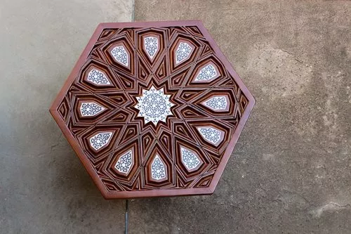 Among the Design Hub’s inaugural collection were, top, “Muzhir Tea Box,” by Nesreen Sharara, who used materials and a pattern inspired by the minbar of Abu Bakr Mazhar (see opposite, lower). “Lajin Tray,” above, by Hana al-Masry, uses a star and arabesque from the minbar of Sultan Lajin. right Tuhfajji (traditional carpenter) Sabry Saber made “Mu’ayyad Table” with a 12-point design found along the balustrade of the minbar of Sultan al-Mu’ayyad Shaykh.
