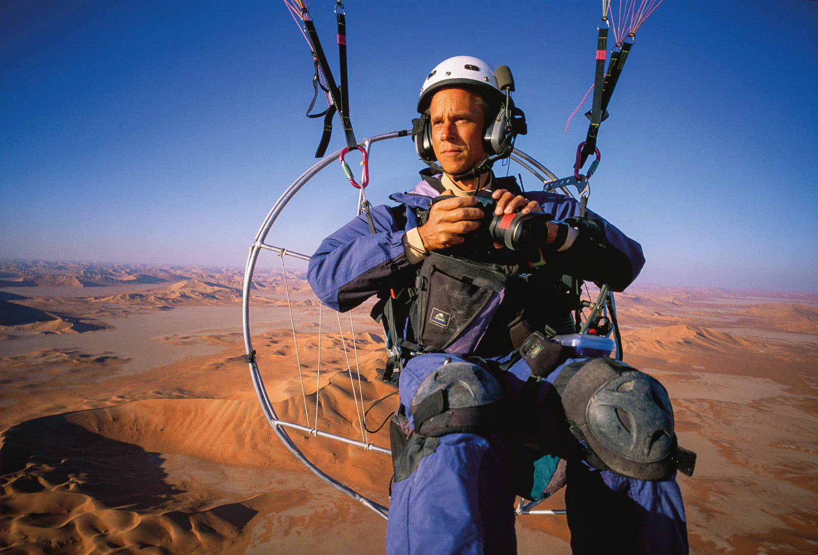 Using a pole-mounted camera attached to his shoe, photographer George Steinmetz once took a self-portrait while piloting a motorized paraglider.