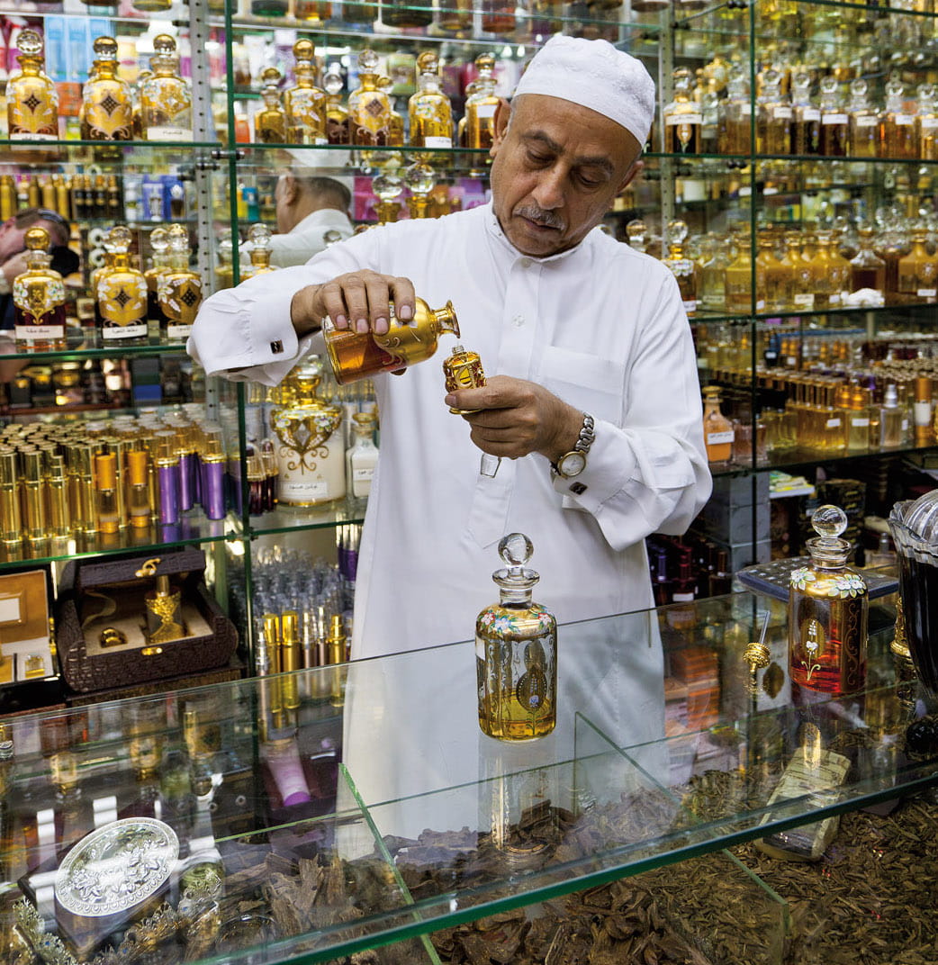 A salesman at a perfume shop in Saudi Arabia’s Eastern Province fills an oud bottle for a customer. (Glynne Joseph Pritchard/Getty Images)