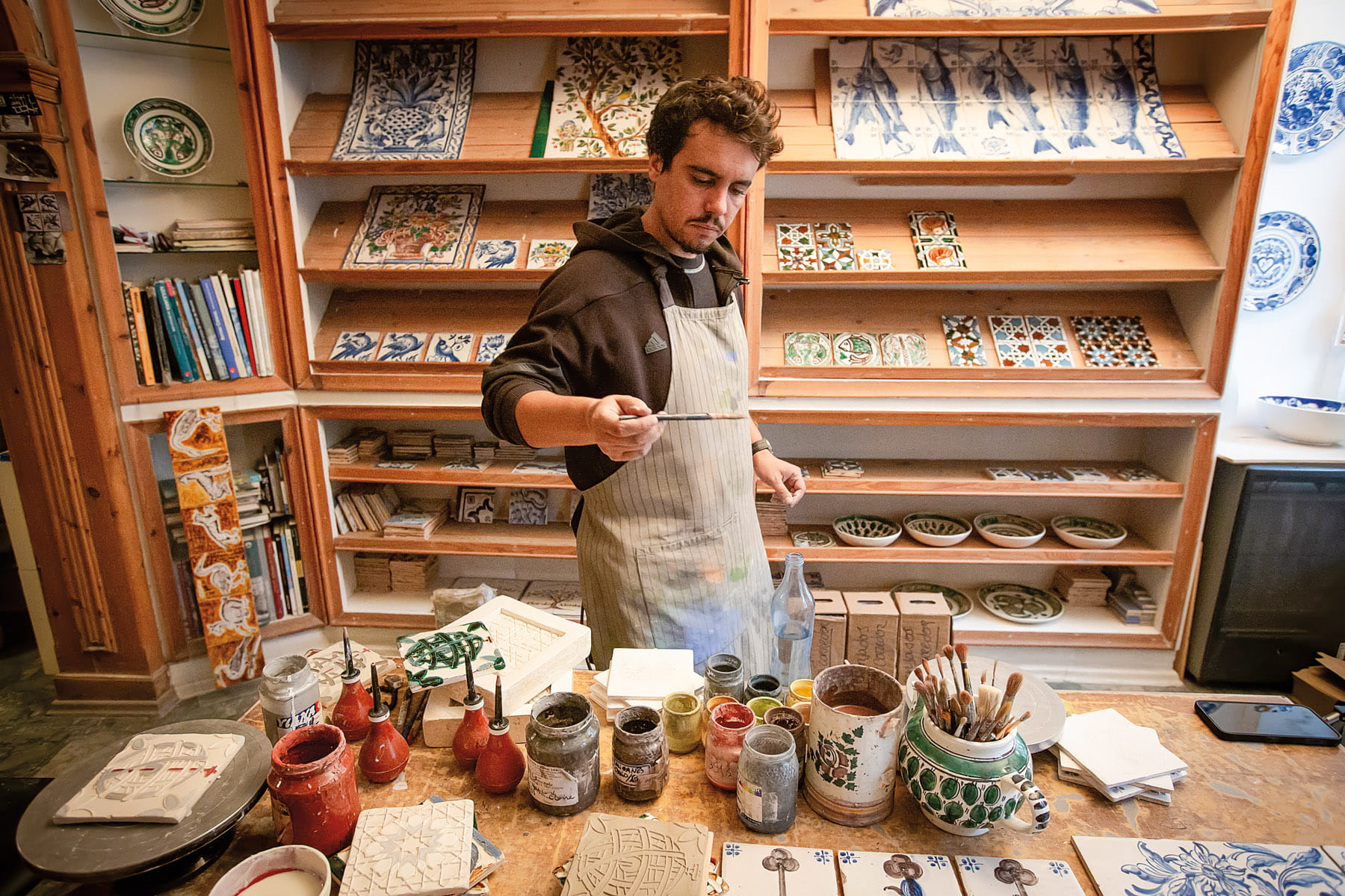 Third-generation tilemaker Miguel Moura works on a Moorish tile design at his workshop in Lisbon.