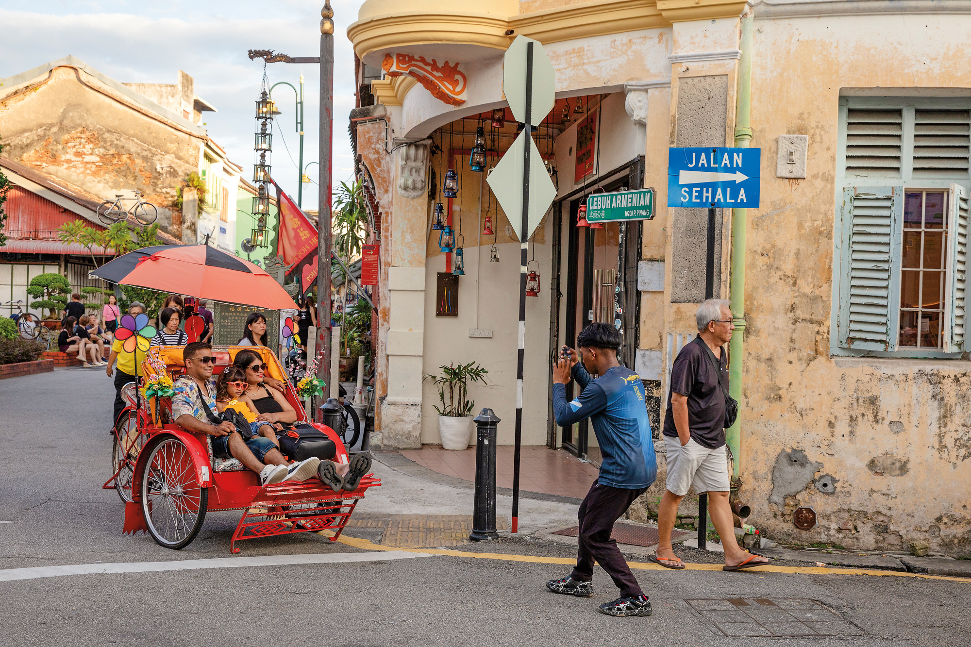 A rickshaw carries tourists along Armenian Street, once a bustling lane for Asian traders that today forms part of George Town’s vibrant heritage-tourism circuit.