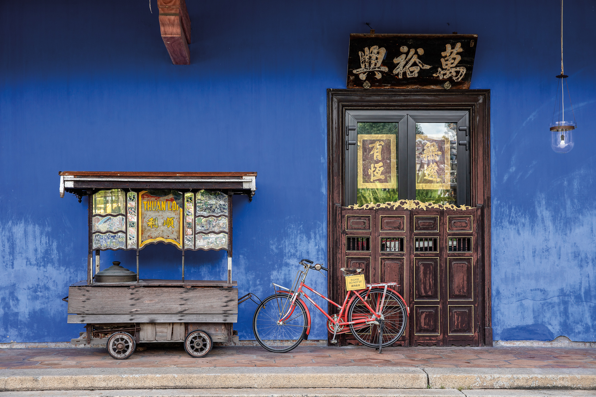 Top and above Loh-Lim Lin Lee leads a tour of the Cheong Fatt Tze Mansion, known as the Blue Mansion, in George Town, Penang, Malaysia. Restoration of the 19th-century residence revived its indigo façade, carved timberwork and traditional Chinese courtyard layout. The project became a model for heritage conservation..