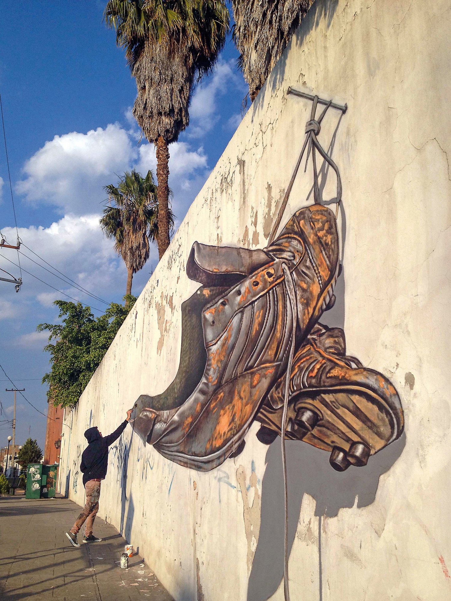 Muralists Juandrés Vera, Dazer Ramírez and Peter Westerink's optical illusion lends a worn pair of football boots a 3D effect in Salamanca, Mexico.
