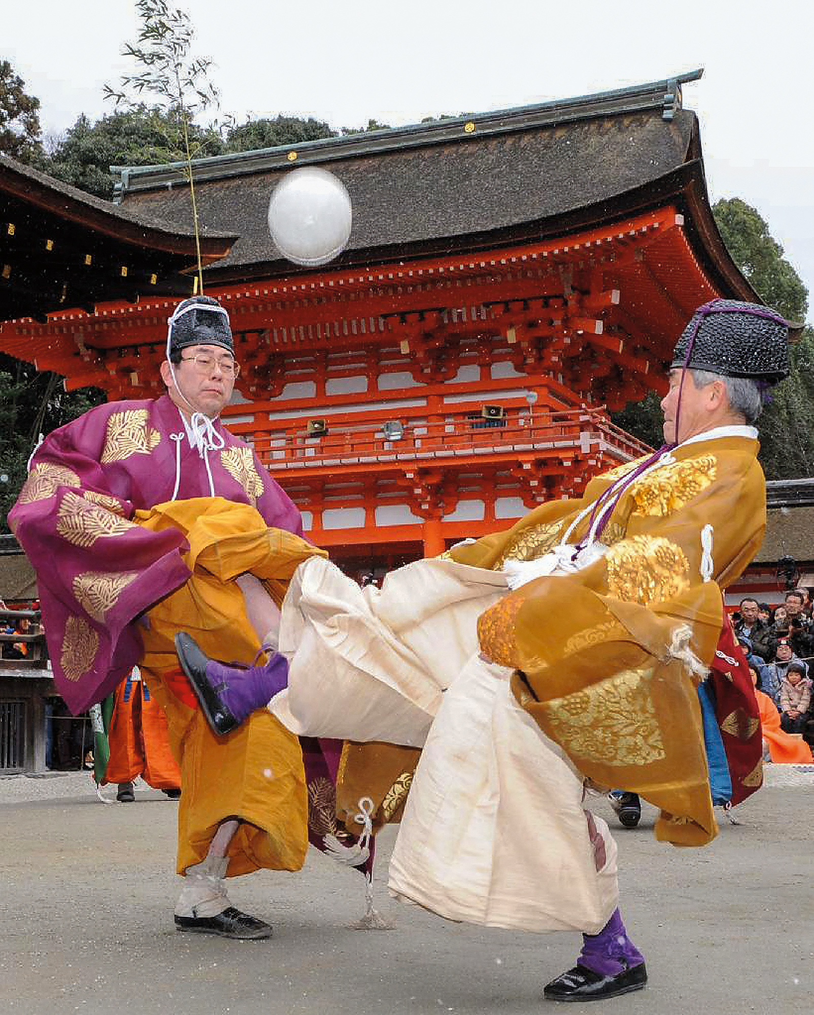 Reenactors in traditional kimonos practice kemari, a Japanese predecessor of football, in 2012 at Shimogamo Shrine in Kyoto.