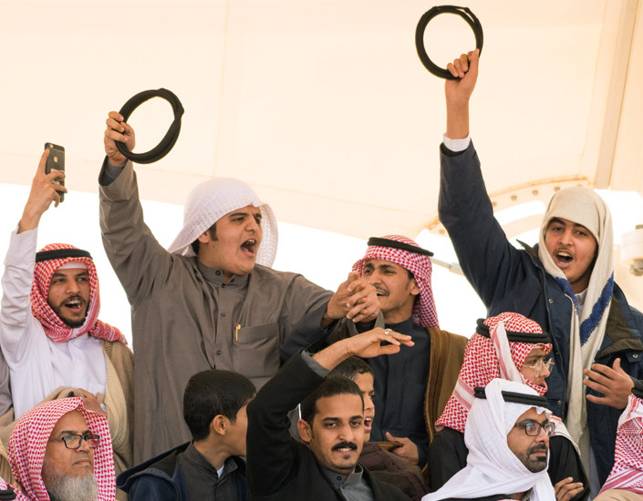 Spectators cheer on favored camels competing in dozens of categories for racing, beauty, obedience and more.