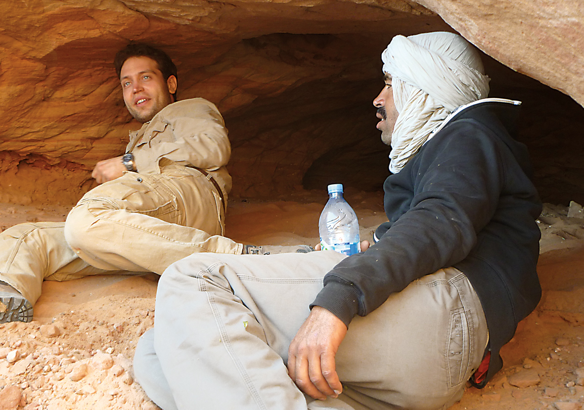 Ibrahim, at left, and an assistant rest at a dig site on &ldquo;The River of Giants.&rdquo;