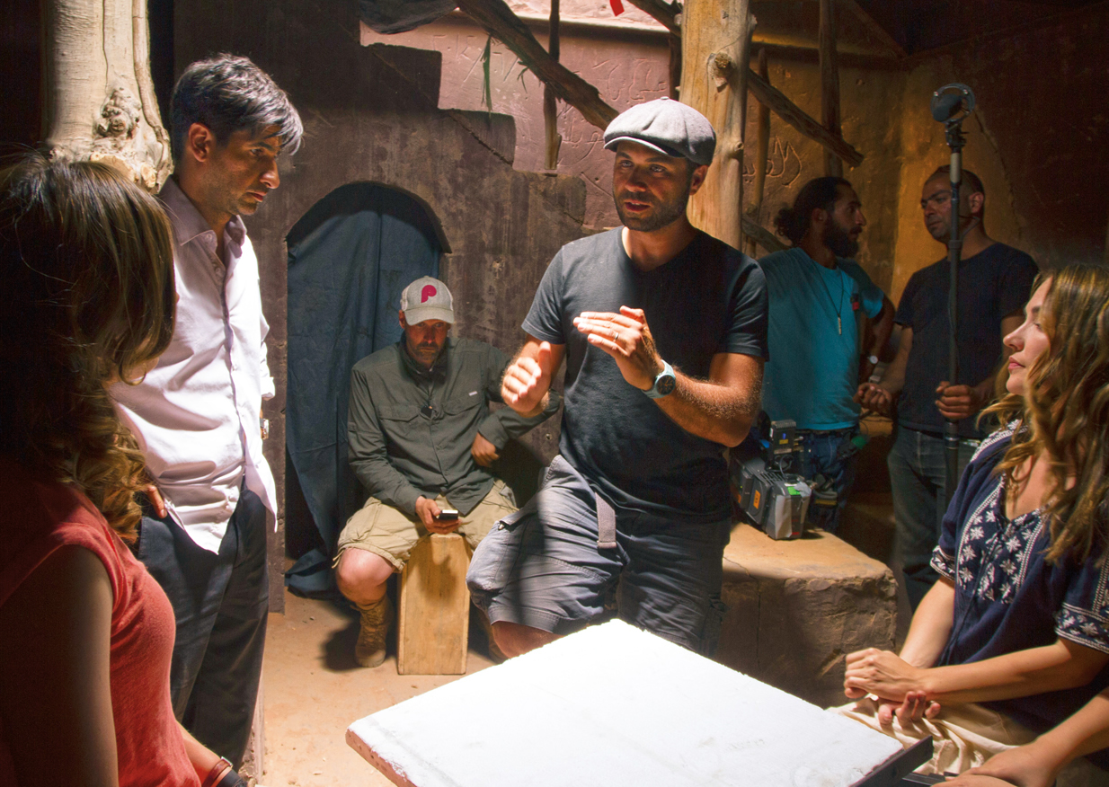 On the set of <em>The Rendezvous, </em>Jordanian-born director Amin Matalqa works with actors (from left) Stana Katic, Raza Jaffrey and Meg Cionni.