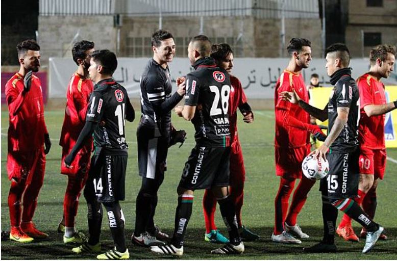 Palestino players shake hands with players from&nbsp;the Hebron Stars&nbsp;prior to&nbsp;a&nbsp;1-1 draw match at al-Hussain Ali stadium in Hebron, Palestine, on December 15, 2016. The friendship game was part of the Chilean club&#39;s&nbsp;week-long visit, during which they&nbsp;played Palestinian teams, toured historical sites, met people and held soccer skills clinics, all to help&nbsp;connect the team to its&nbsp;origins.