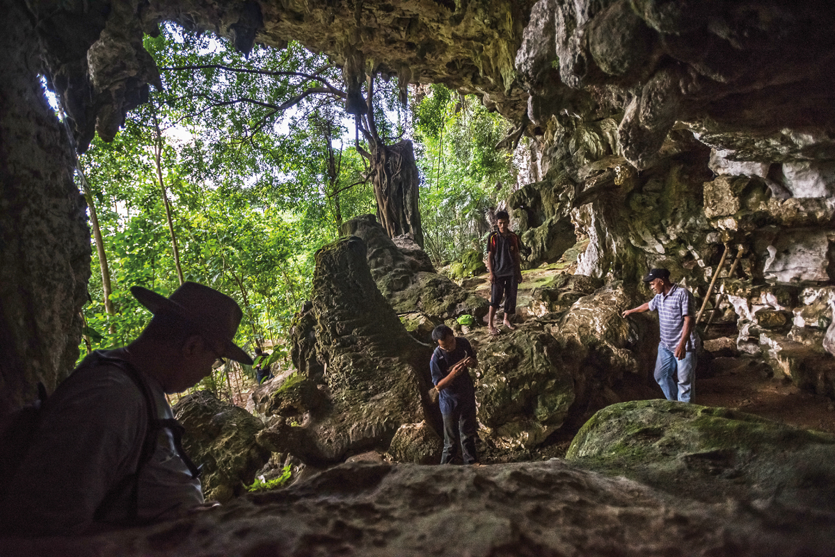 Archeologists and guides explore Leang Jarie (&ldquo;Hand Cave&rdquo;), one of several recently discovered homes to some of the world&rsquo;s oldest hand stencil-paintings.