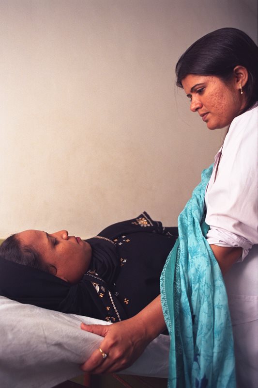 A woman is treated in the North Karachi Center.