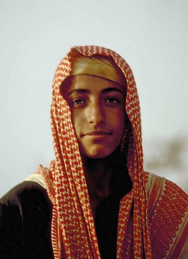 Posing for a portrait in 1975 in the &lsquo;Asir region of Saudi Arabia, a young man wears a traditional red-and-white kufiya, called a <i>shamagh</i> in Saudi Arabia.