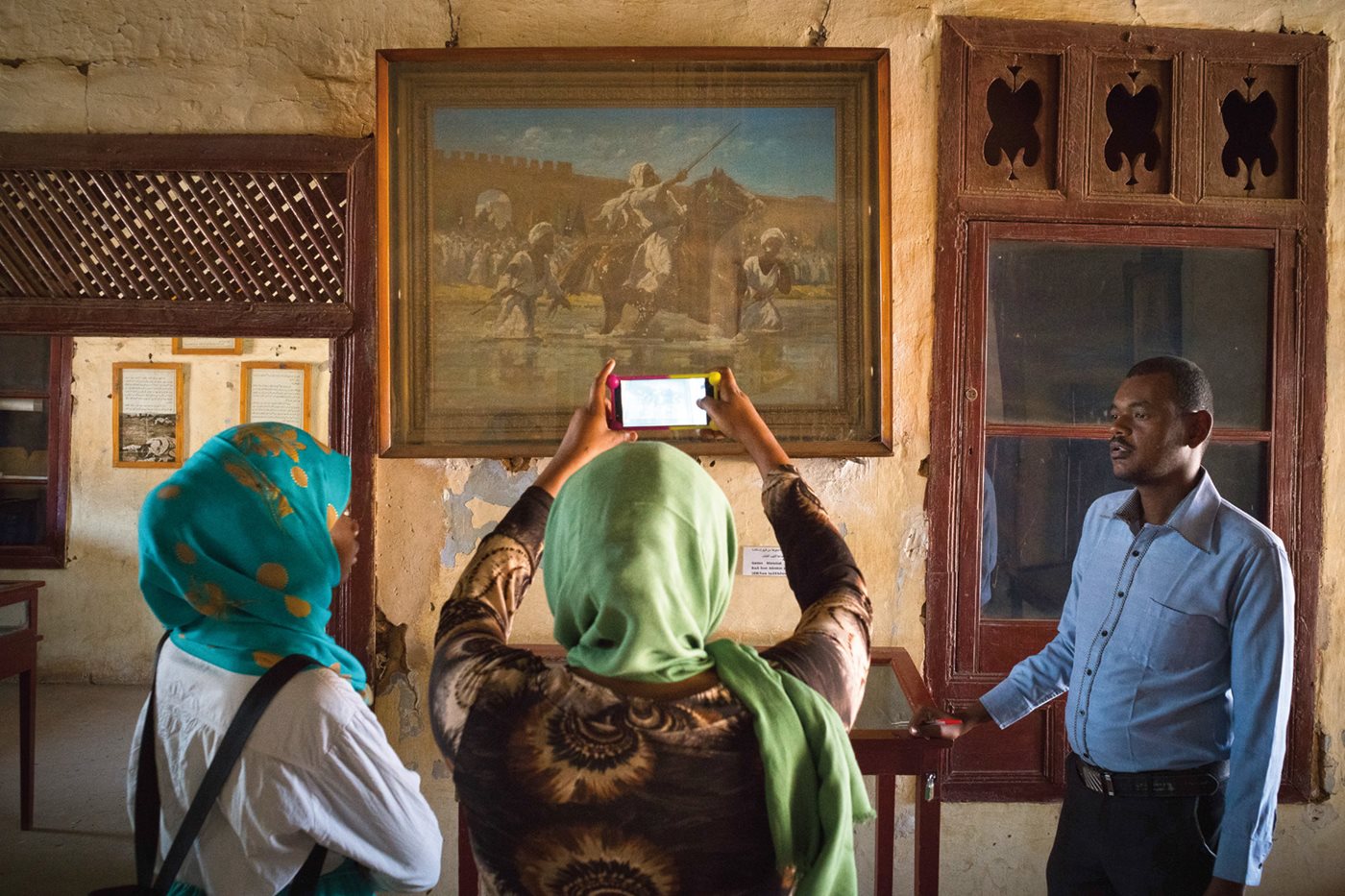 Visitors view a battle scene at the Khalifa House Museum in Omdurman, which became the capital after Sudanese forces under Muhammad Ahmad ibn al-Sayyid defeated Anglo-Egyptian troops in 1885. In 1898 the British recaptured Omdurman from Adullahi ibn Muhammad, whose house is the site of the museum. Independence came to Sudan in 1956.