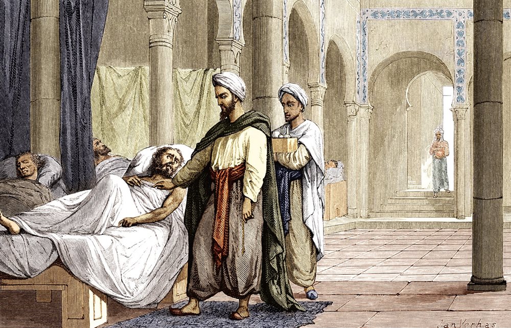 <p>Depicting a scene in the hospital at Cordóba, then in Al-Andalus (Muslim Spain), this 1883 illustration shows the famed physician Al-Zahrawi (called Abulcasis in the West) attending to a patient while his assistant carries a box of medicines. </p>