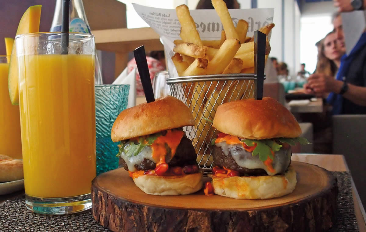 Camel sliders and fries with mango juice at Louvre Abu Dhabi café.