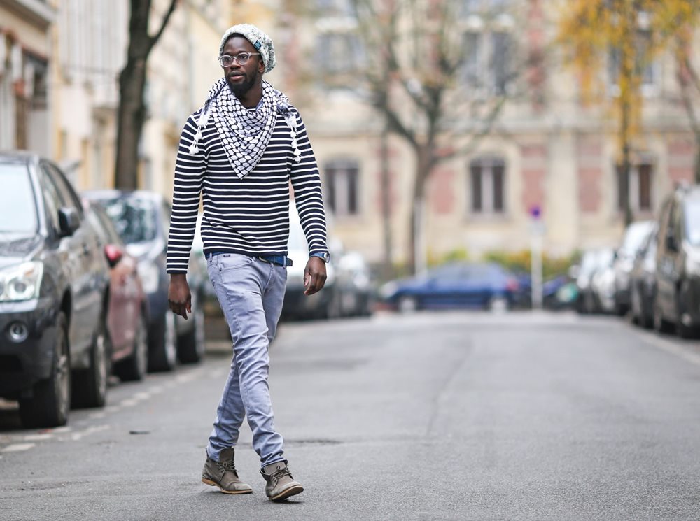 In Paris, model Sidya Sarr wears a traditional black-and-white kufiya less for utility and more for street style.