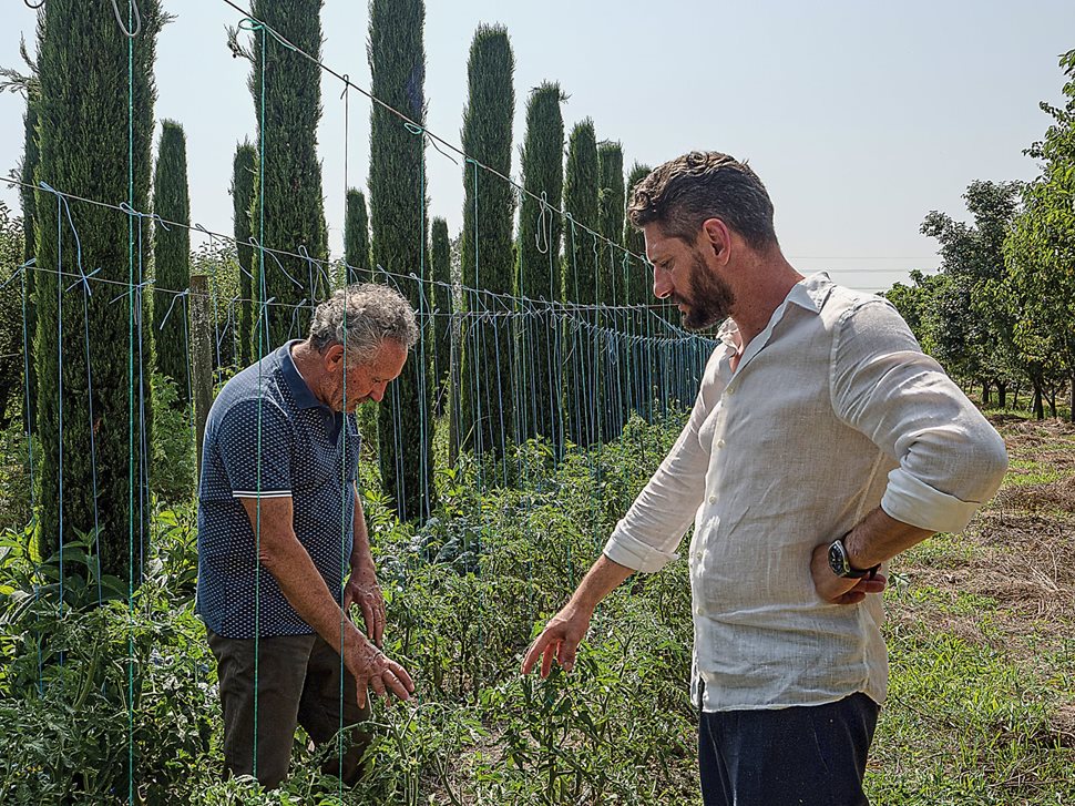 Rexhep Uka, left, Albania’s former Minister of Agriculture, and his son Flori Uka check on organically grown tomatoes at their Uka Farm in Laknas, near Tirana. By growing indigenous and other key ingredients, farms are driving the rebirth of Albanian cuisine. 