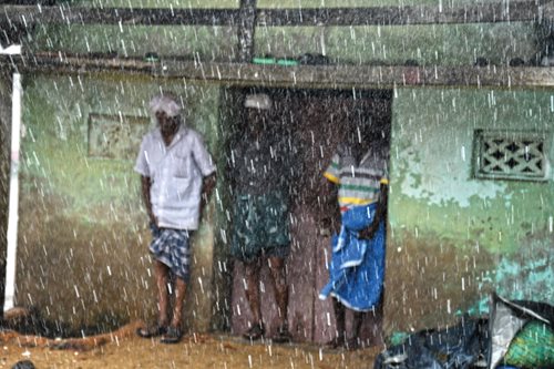 In a village near the Port of Ponnani, residents take shelter from the monsoon rains that come to India’s west coast on the same winds that have brought centuries of maritime trade that link Arabs and others to Kerala.