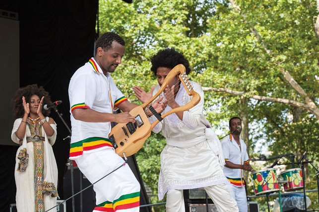 Temesgen Zeleke of the Ethiopian band Krar Collective plays an electric krar, a five-or-six stringed, bowl-shaped lyre, during a performance at New York’s Central Park Summer Stage in 2013. The basic shape and structure of the instrument mimics that of its earliest ancestors, but this lyre is electrified to produce contemporary sounds. 