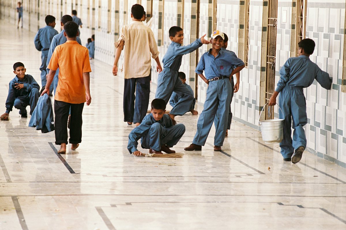 At the Edhi Child Home on the outskirts of Karachi, boys wash the assembly-hall floor as part of morning chores. The 26-hectare (65-acre) campus is home to more than 250 boys; it is part of the Edhi Village complex that also houses some 1500 patients with mental illnesses.