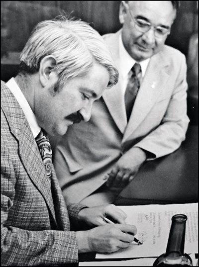 <p><em>Above: </em>At a ceremony in Seattle in 1973, Seattle Mayor Wes Uhlman put his signature on a sister city memorandum after Tashkent Mayor Vahid Kazimov, who looks on. <em>Below:</em> In 1989, the Hotel Uzbekistan in Tashkent welcomed a Seattle delegation in three languages: Uzbek, English and Russian.&nbsp;</p>
