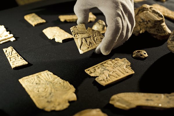A specialist handles pieces from the collection of Nimrud Ivories at the British Museum. Although ivories from Nimrud have been acquired and displayed by museums around the world, the largest collections are held by the National Museum of Iraq and the British Museum.