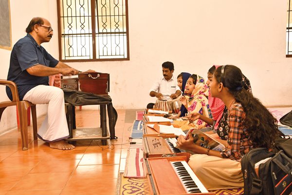 Mappila pattu teacher and harmonium player, Master Ahmet, left, offers instruction at the Mappila Academy in Kondotty, one of Kerala’s largest cultural centers specializing in music education.